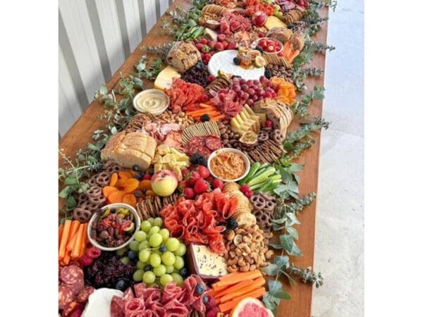 A vibrant seafood and veggie feast on a long wooden table.
